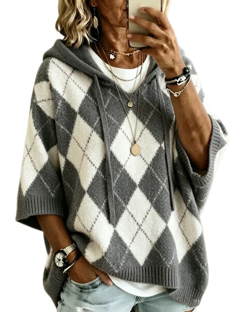 Woman wearing charcoal argyle hooded knit sweater, front view
