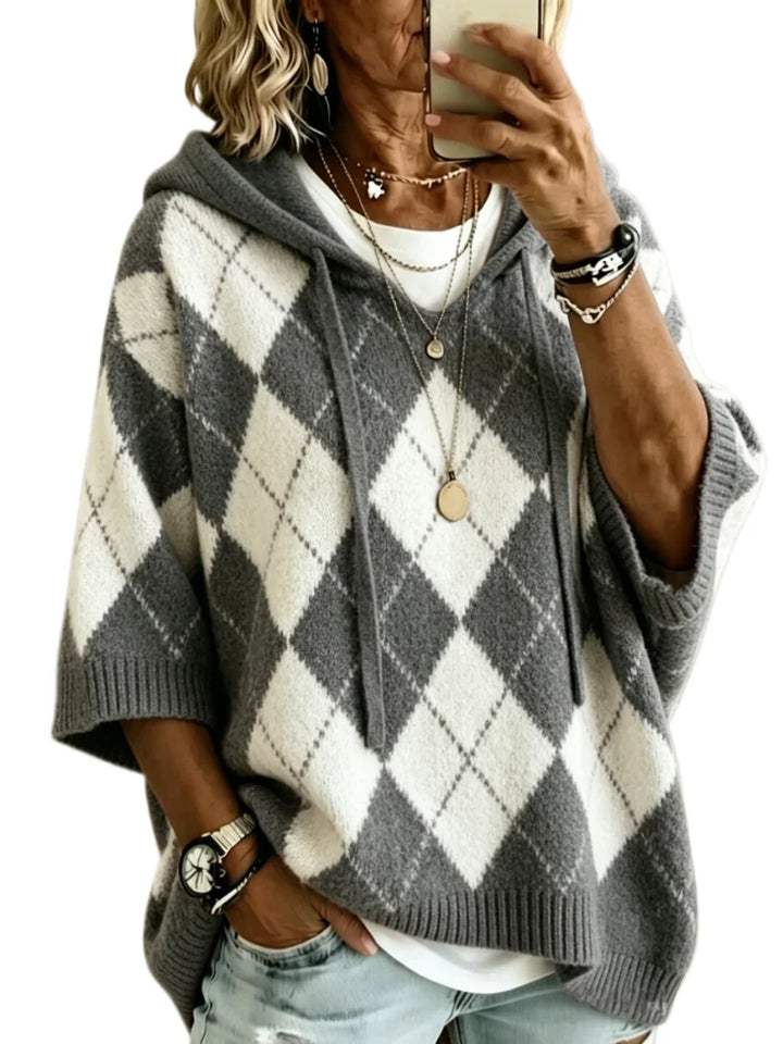Woman wearing charcoal argyle hooded knit sweater, front view