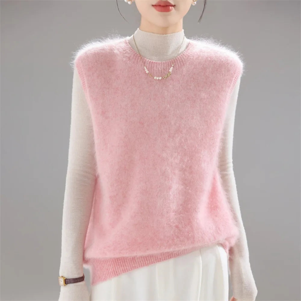Pink brushed knit sweater vest worn over cream turtleneck