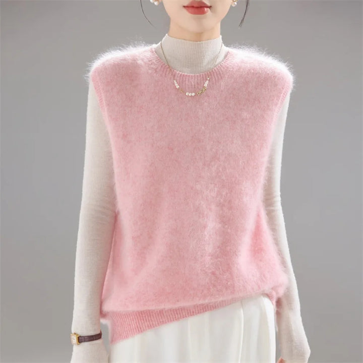 Pink brushed knit sweater vest worn over cream turtleneck