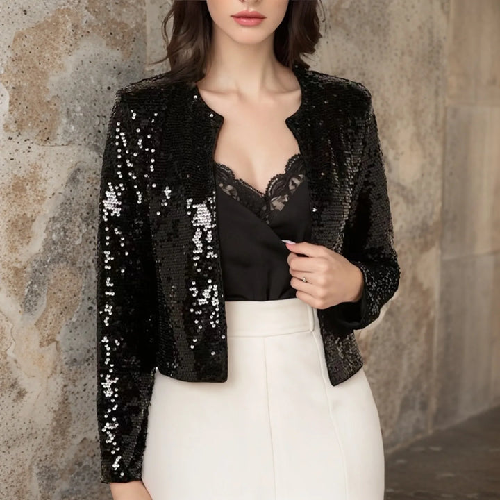 Black sequin cropped jacket worn open over black lace top