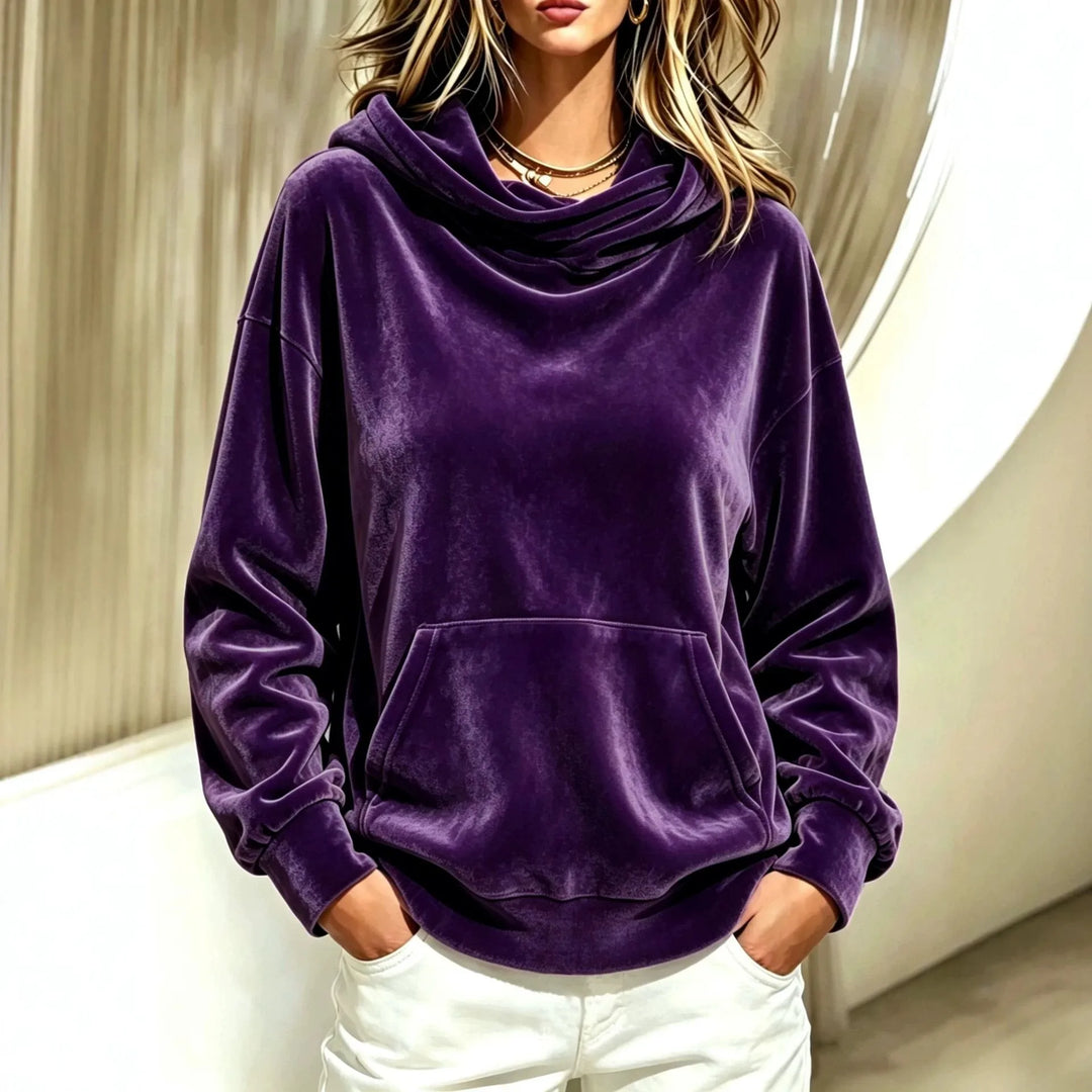 Woman wearing purple velour hoodie with cowl hood and kangaroo pocket