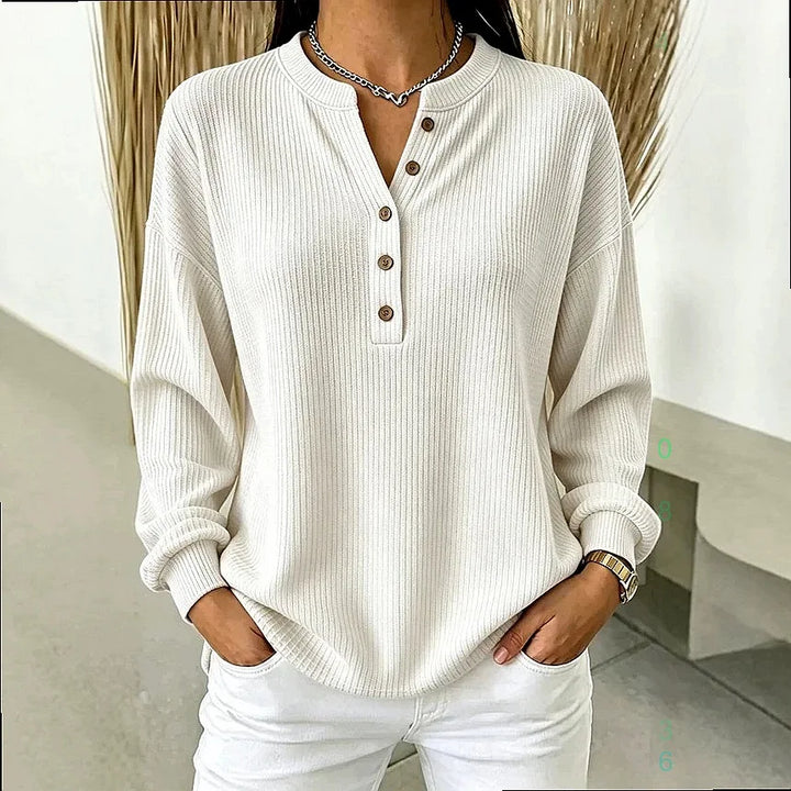 Woman wearing white ribbed knit henley top with button placket