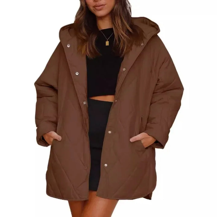 Woman wearing brown diamond quilted hooded jacket with hands in pockets