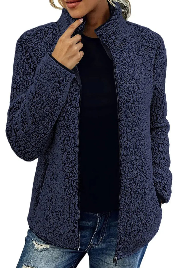 Woman wearing navy blue sherpa fleece zip jacket