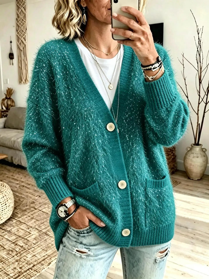 Close up of green eyelash-knit cardigan with button closure