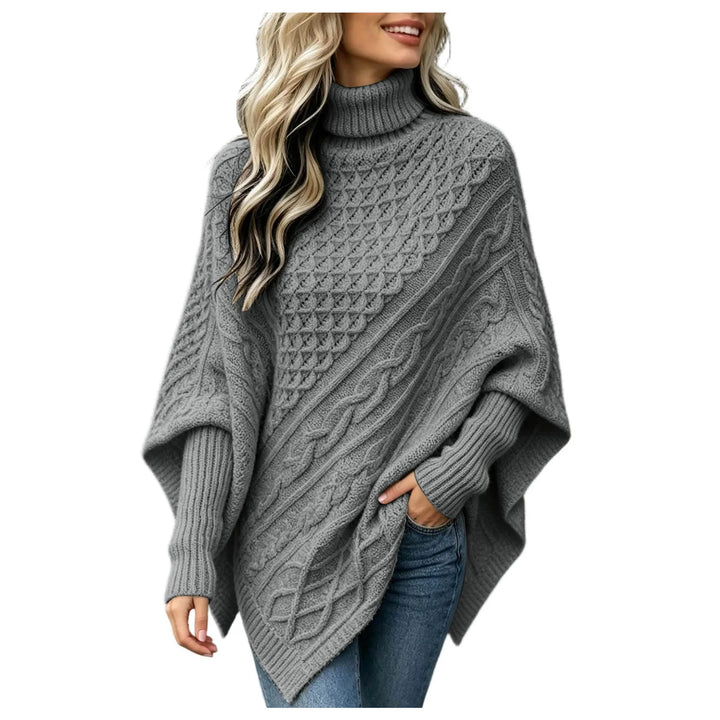 Woman wearing grey cable knit asymmetric poncho sweater with turtleneck