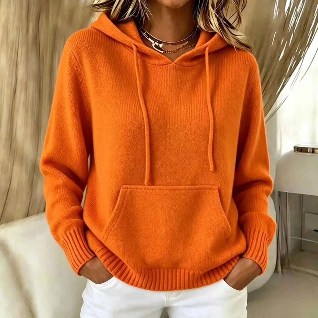 Woman wearing orange hooded knit sweater with kangaroo pocket