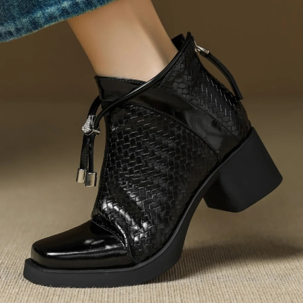 Woman wearing black woven ankle boot with lace tie detail