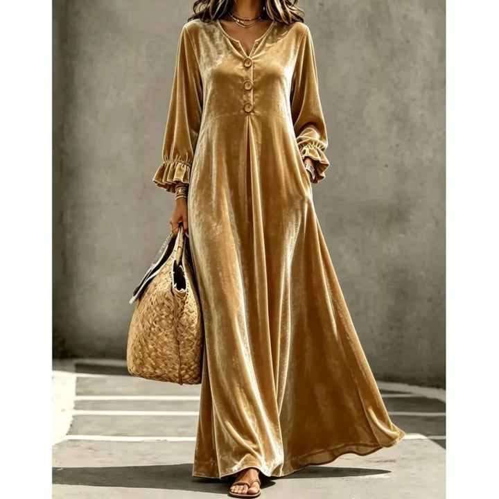 Woman wearing gold velvet maxi dress with button neckline, front view