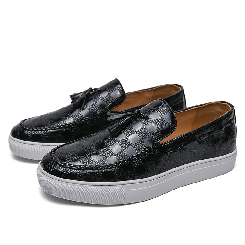 Black diamond-embossed leather loafers with tassel detail, side angle