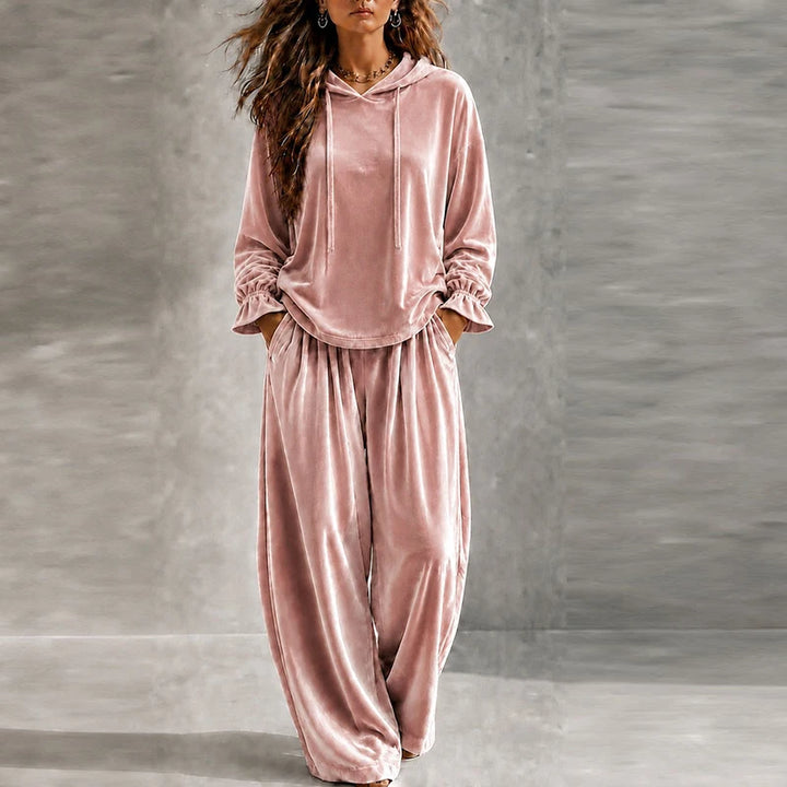 Woman wearing pink velvet hooded tracksuit with wide leg pants