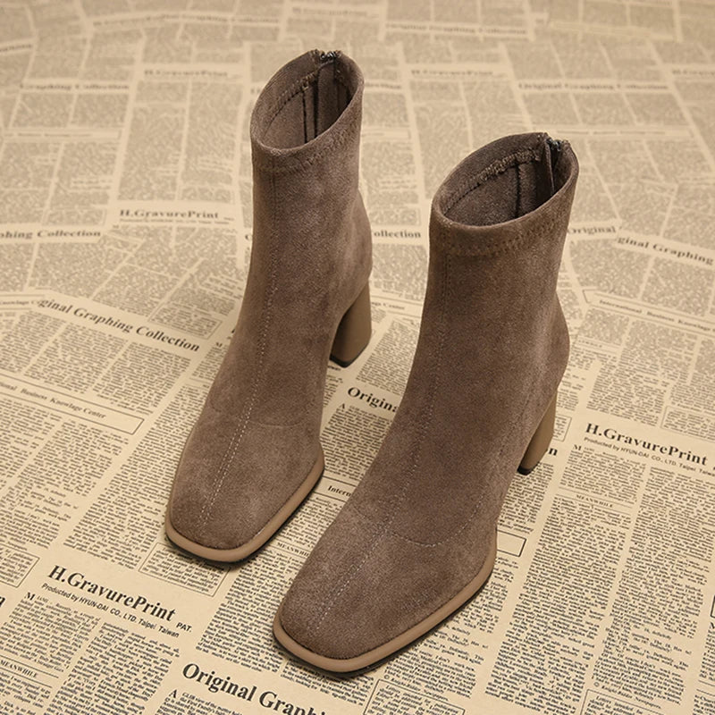 Pair of khaki suede-look ankle boots with block heel, front view