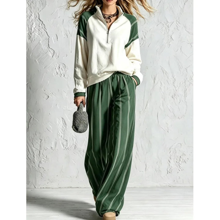 Woman wearing green striped wide leg pants with color block quarter zip pullover
