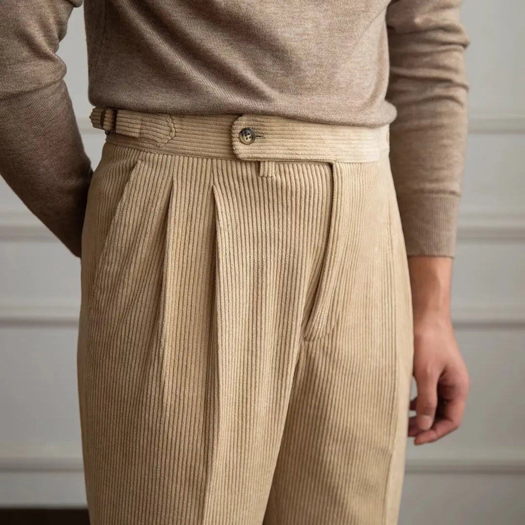 Close up of beige corduroy trousers waistband and pleats