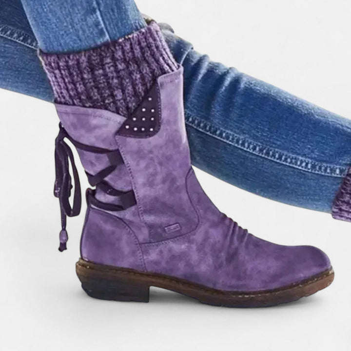 Purple suede winter boot with knit cuff worn with jeans