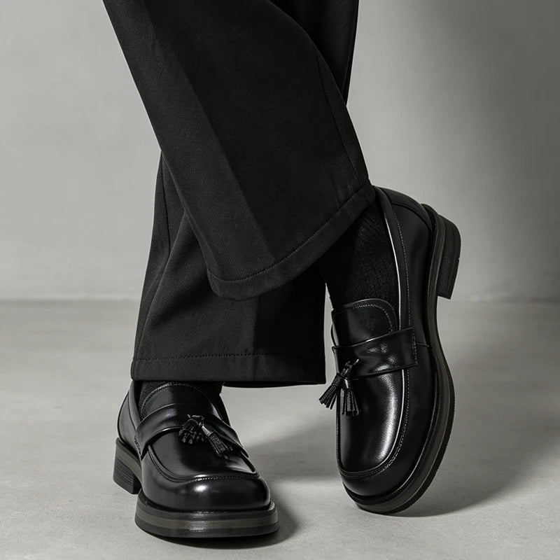 Man wearing black tassel loafers with cropped black trousers