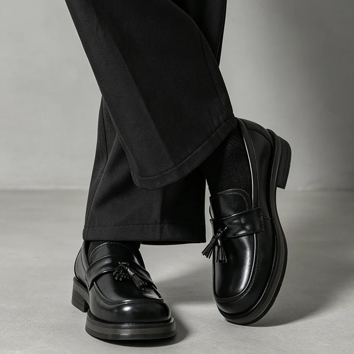 Man wearing black tassel loafers with cropped black trousers