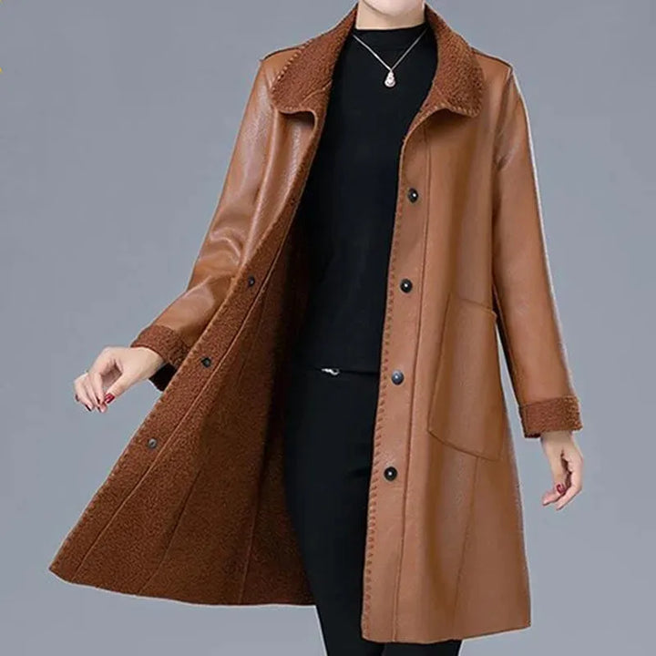 Woman wearing khaki faux leather longline jacket with shearling collar, front view