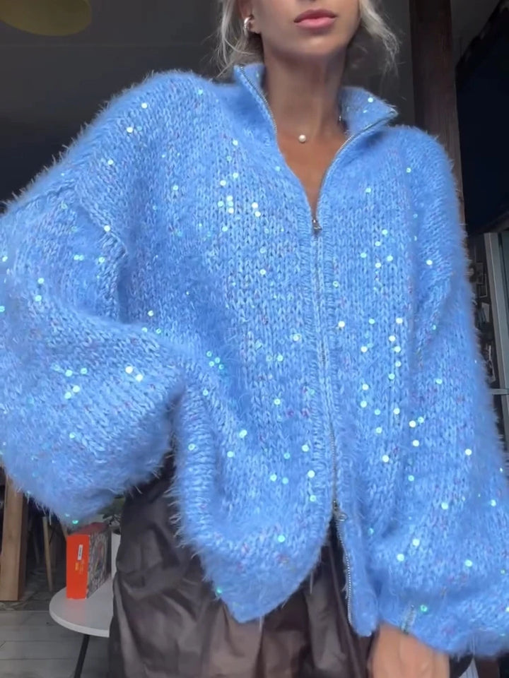 Woman wearing blue fuzzy sequin zip-up cardigan sweater