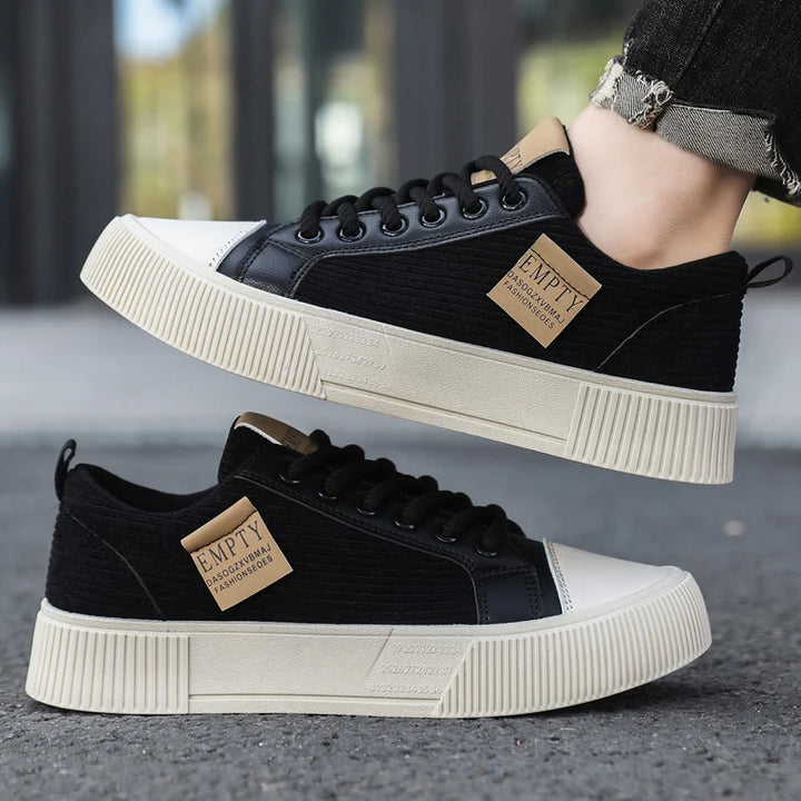 Black sneakers worn on feet outdoors