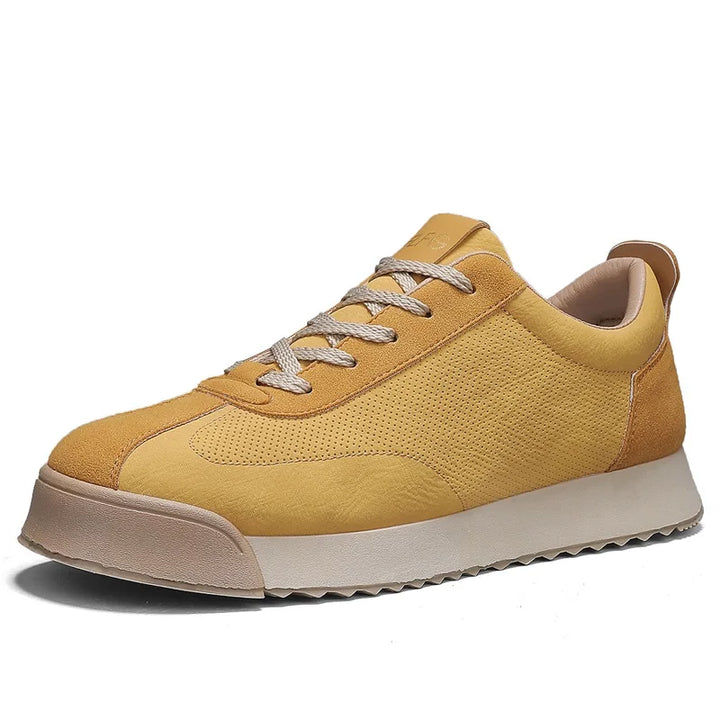 Angled view of yellow sneaker on white background