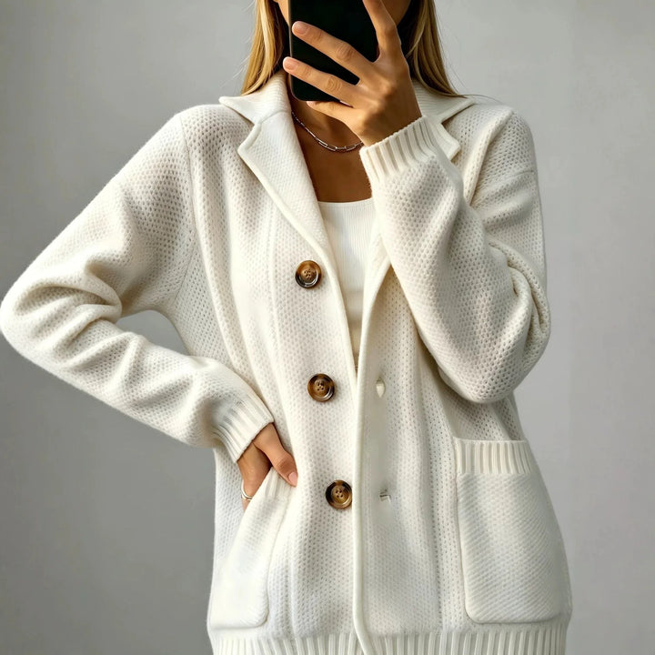 Close up of creamy-white cardigan buttons and patch pocket