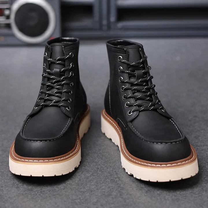 Black leather moc-toe work boots with lace-up front, side view