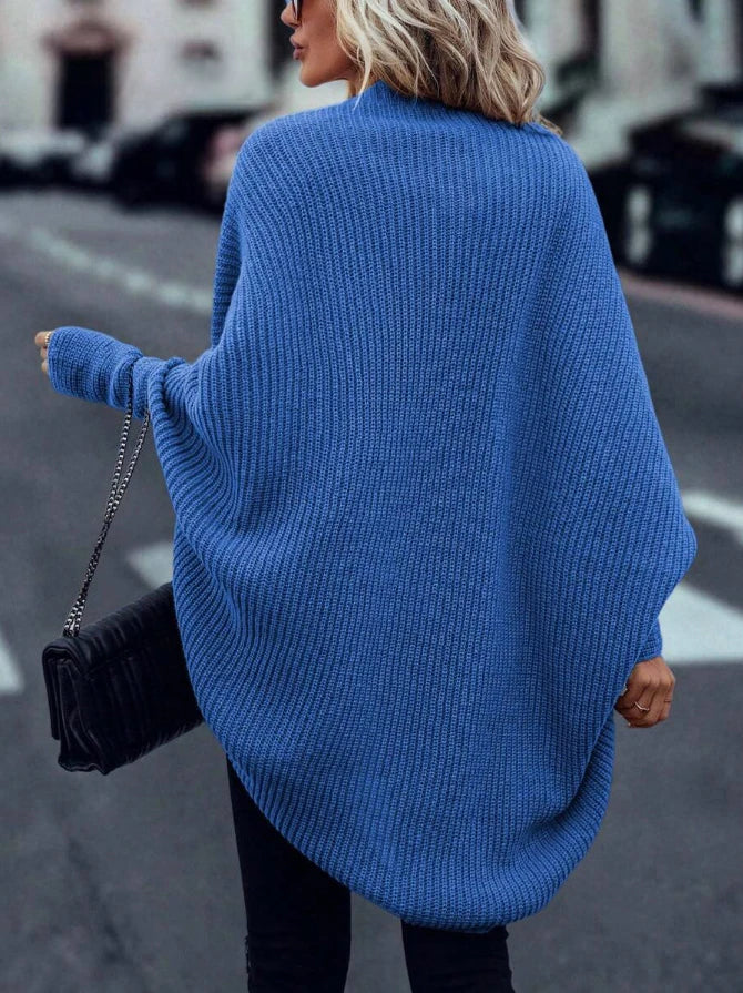 Back view of blue ribbed knit cardigan with dropped hem