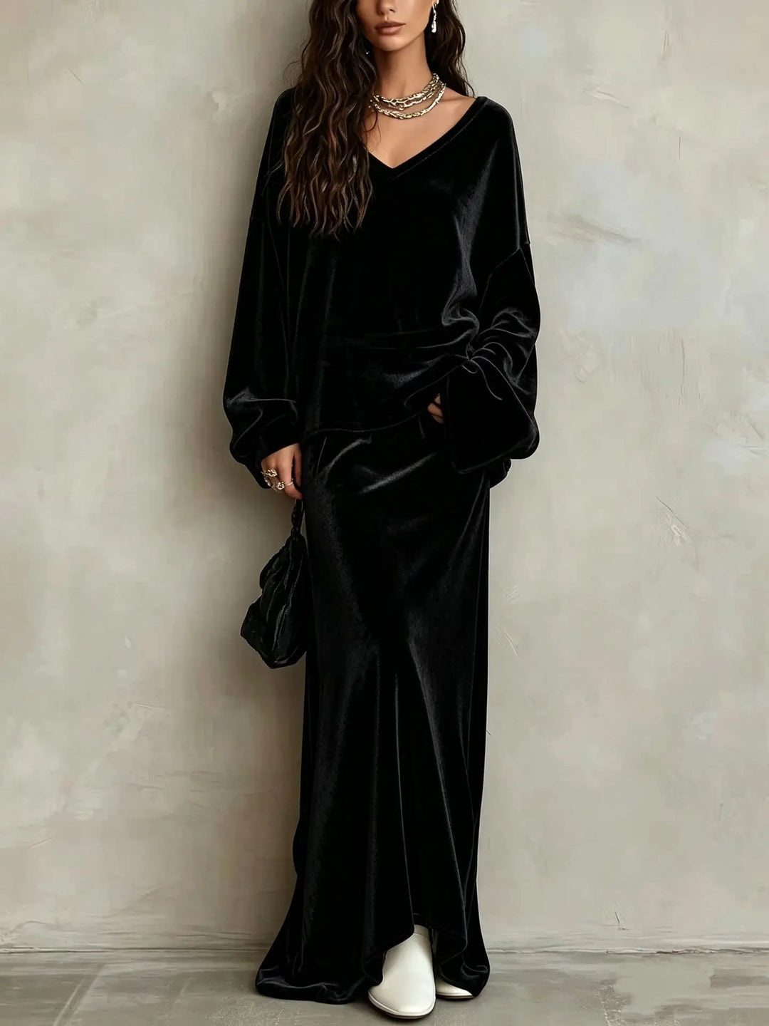 Close up of black velvet V neck pullover and maxi skirt set