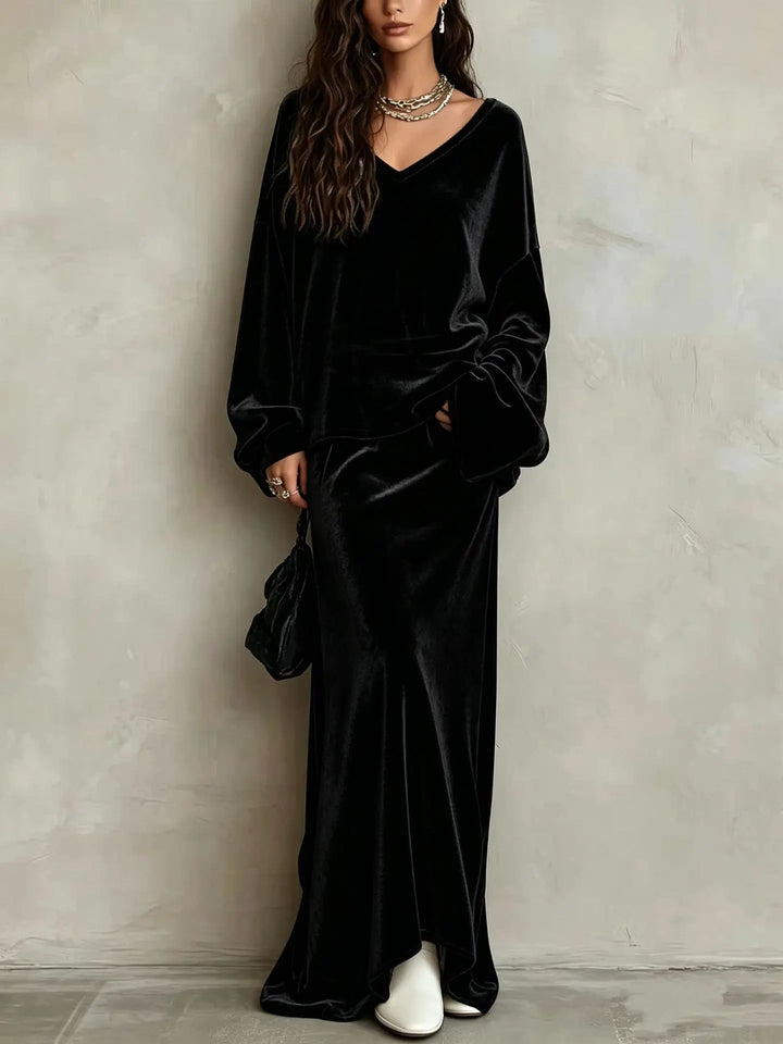 Close up of black velvet V neck pullover and maxi skirt set