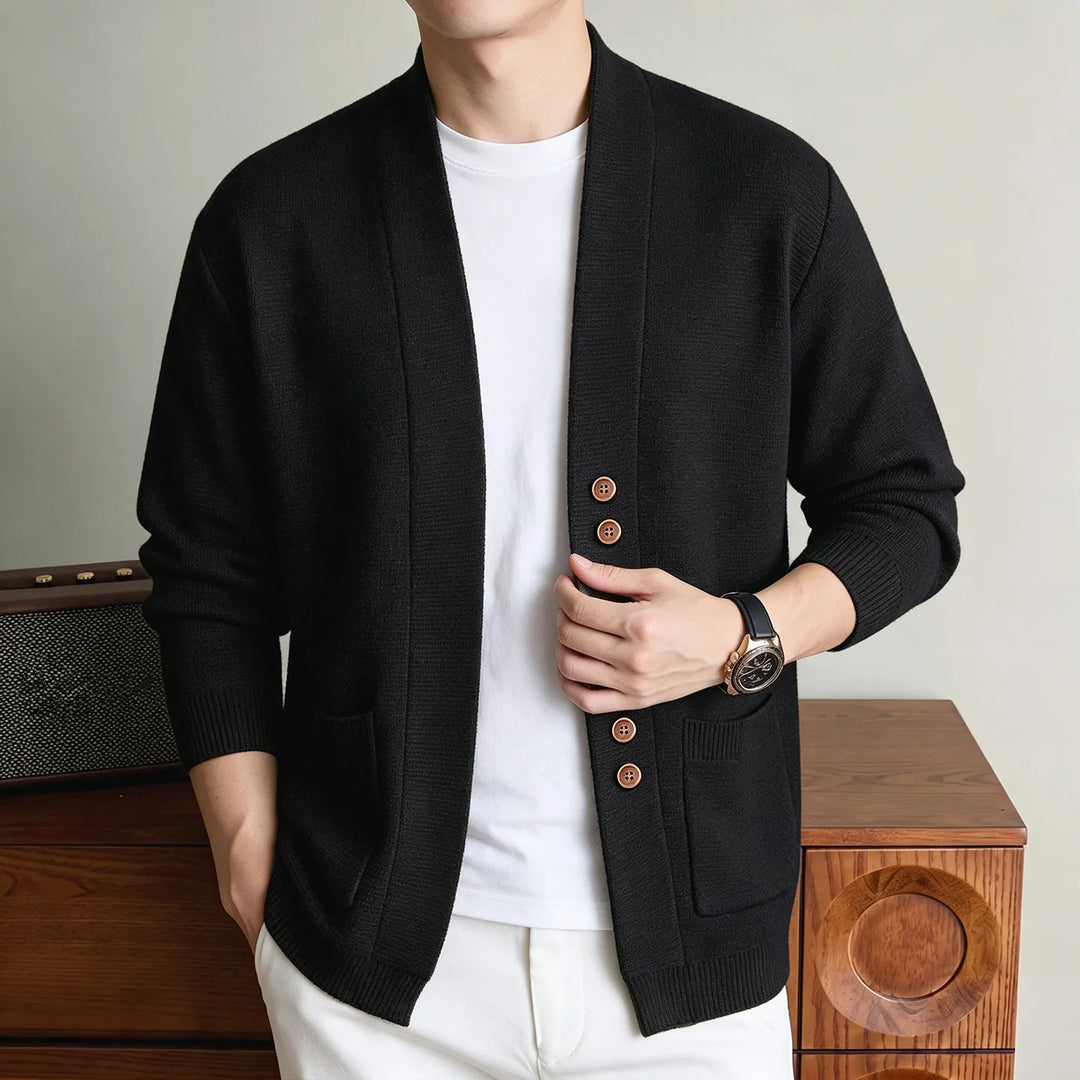 Man wearing black knit shawl collar cardigan with wood buttons