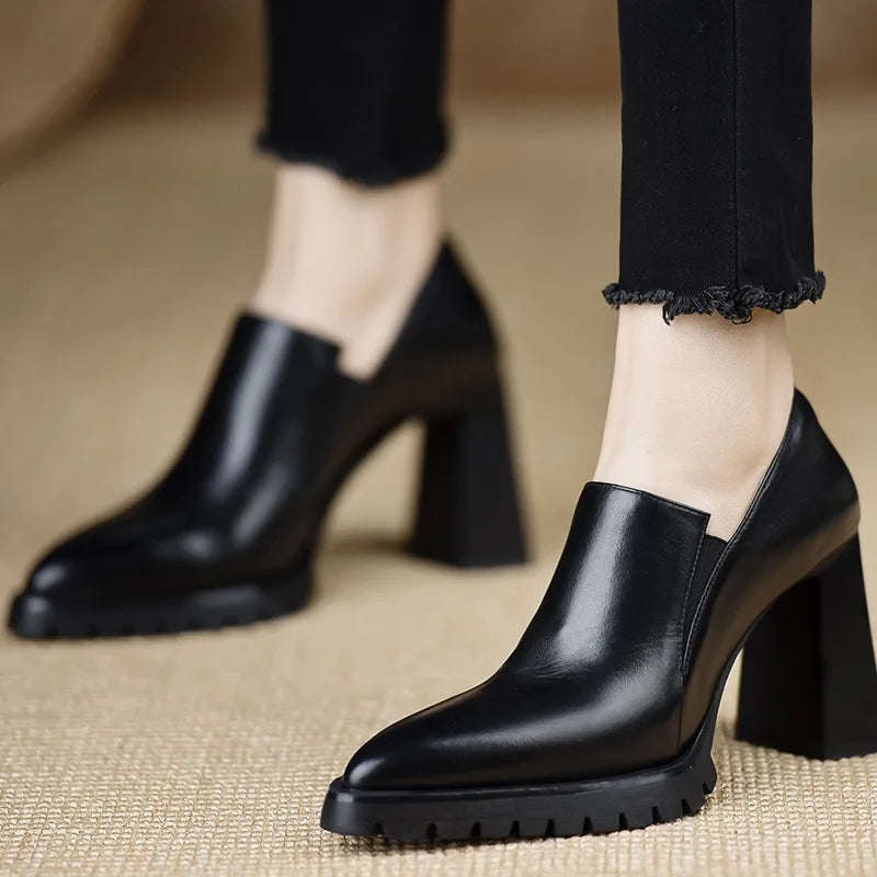 Black leather pointed toe pump with chunky block heel, side view