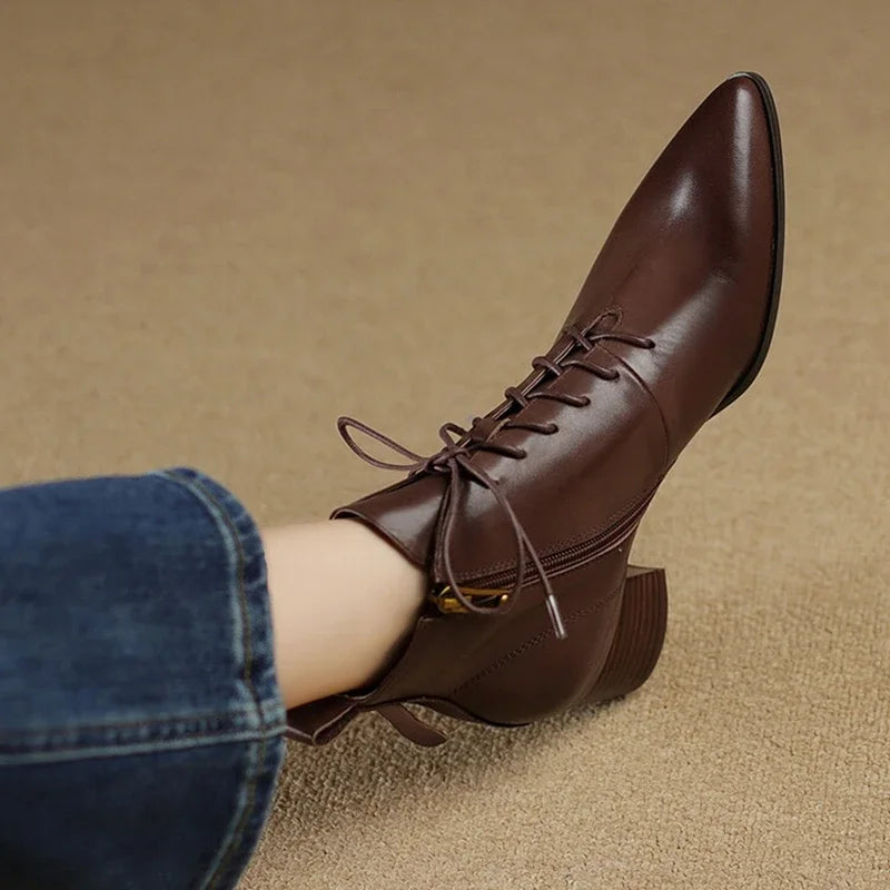 Brown leather ankle boot shown in profile with pointed toe