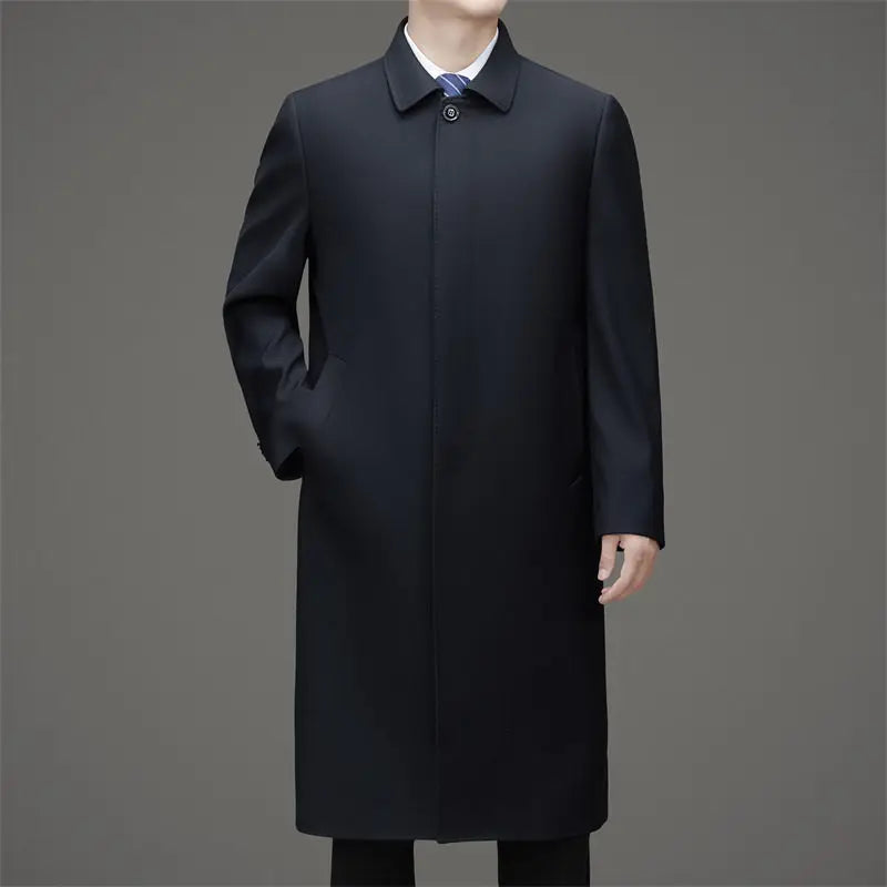Man wearing navy blue long trench coat buttoned, front view