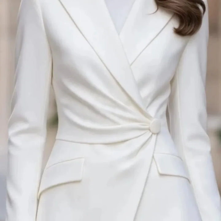 Close up of white blazer twisted waist button detail