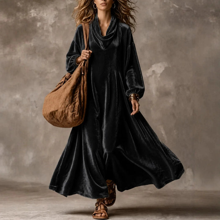 Woman wearing black velvet cowl neck maxi dress