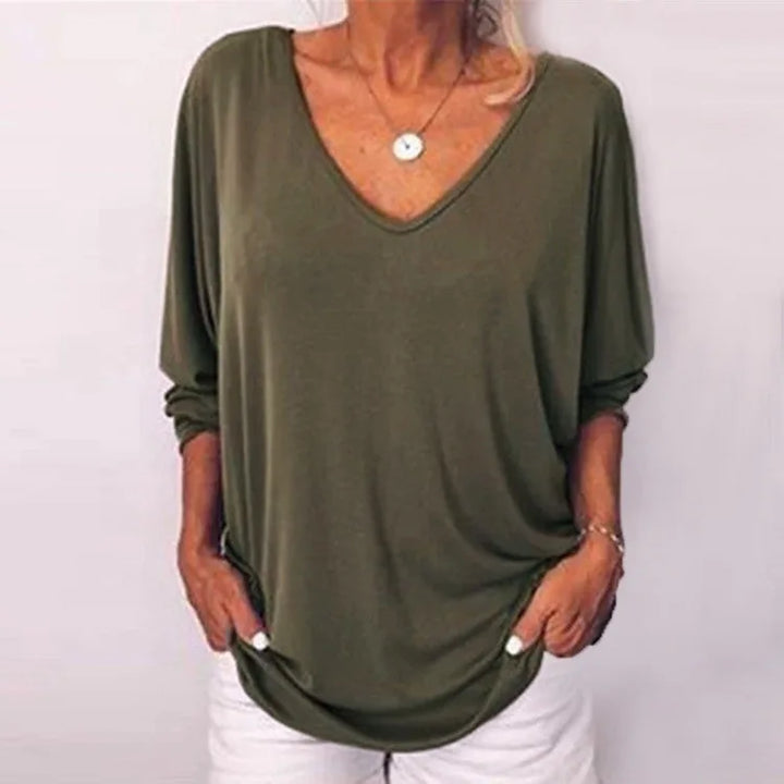 Woman wearing olive green V-neck three-quarter sleeve top, front view