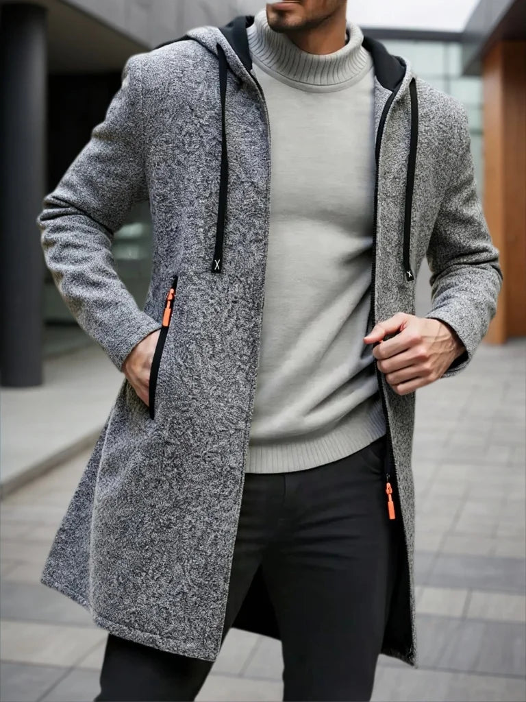 Man wearing dark gray hooded mid-length fleece jacket with zipper detail