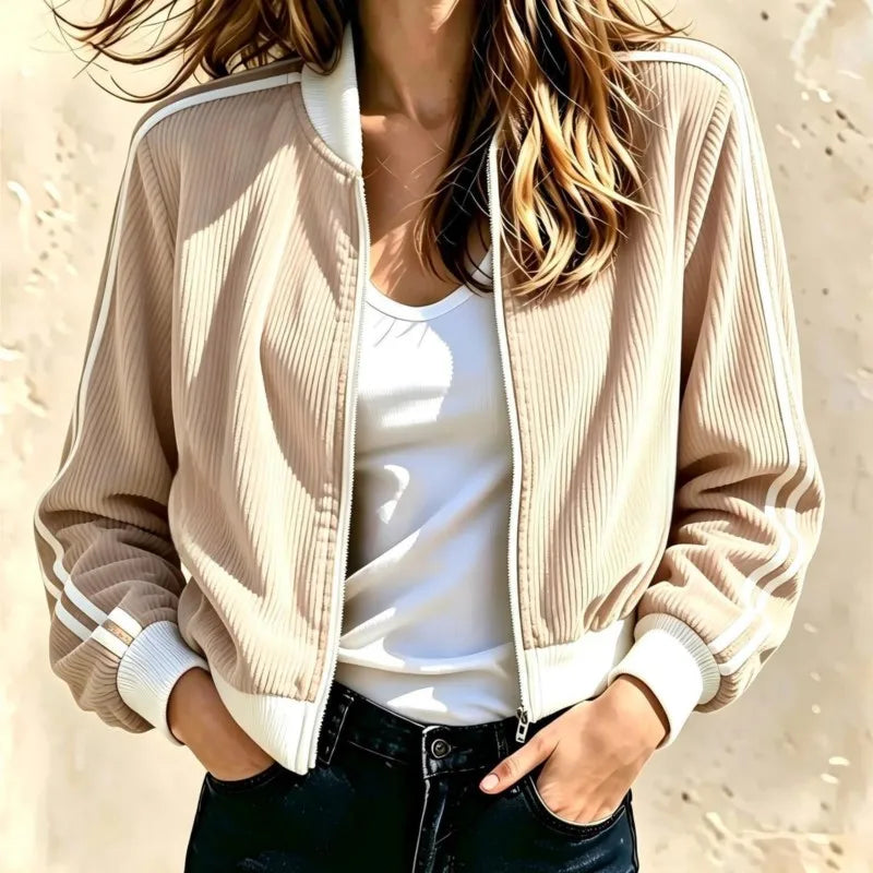 Woman wearing beige corduroy bomber jacket with white stripe trim