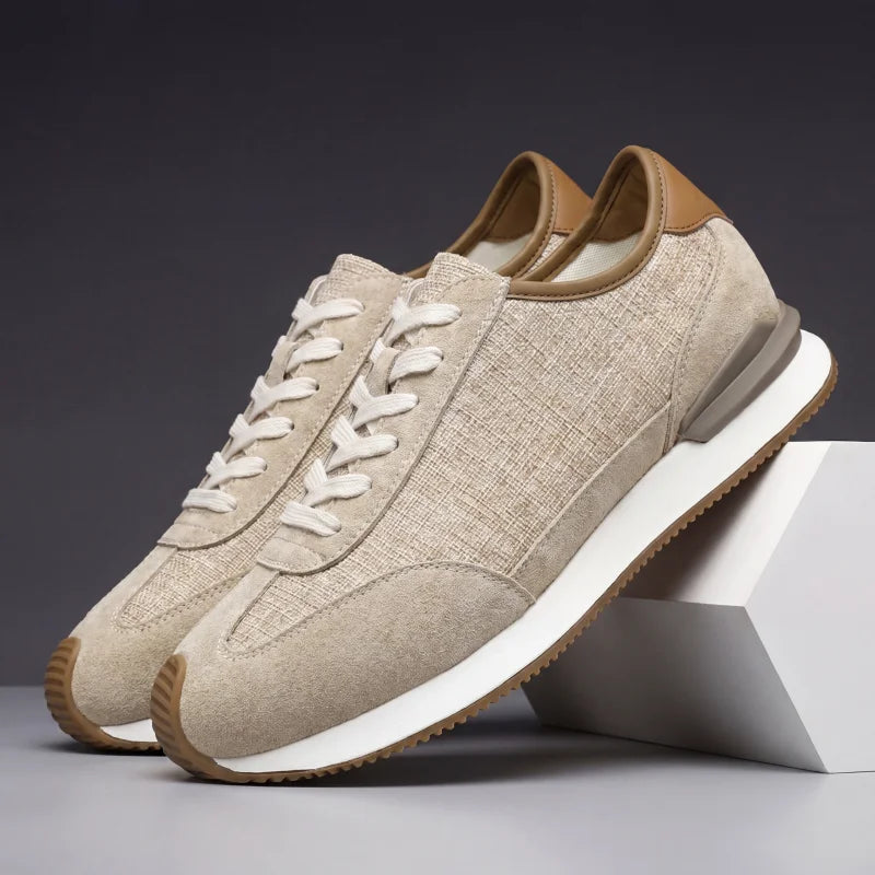 Pair of khaki textured sneakers with tan heel trim, side angle