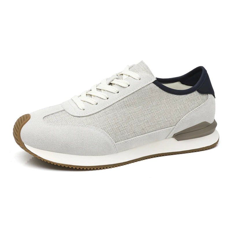 Gray textured sneaker with navy heel tab, side profile