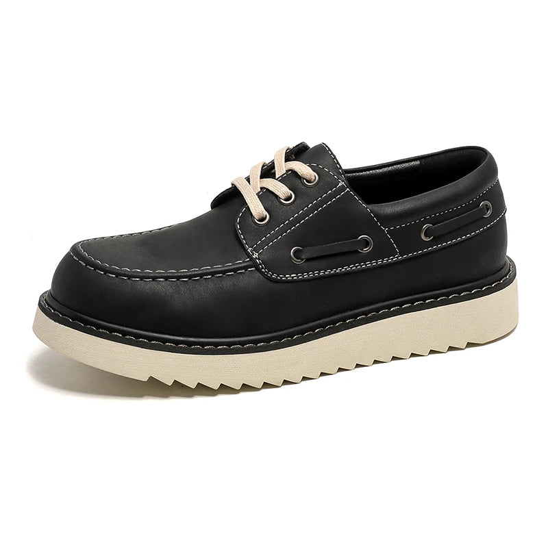 Black leather boat shoe angled view on white background