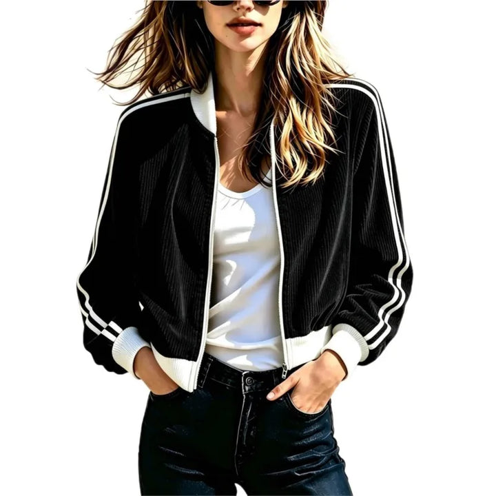 Woman wearing black corduroy bomber jacket with white stripe trim