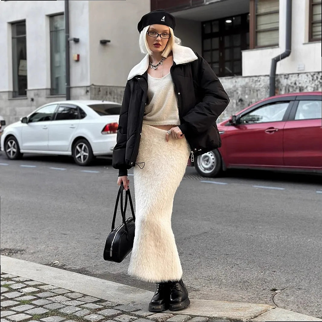 Woman wearing white fuzzy knit maxi skirt with black puffer jacket