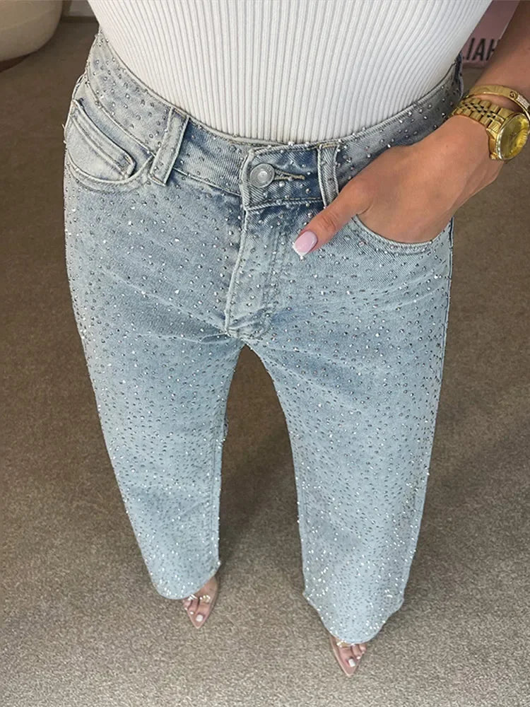 Close up of light blue rhinestone denim waistband and pockets
