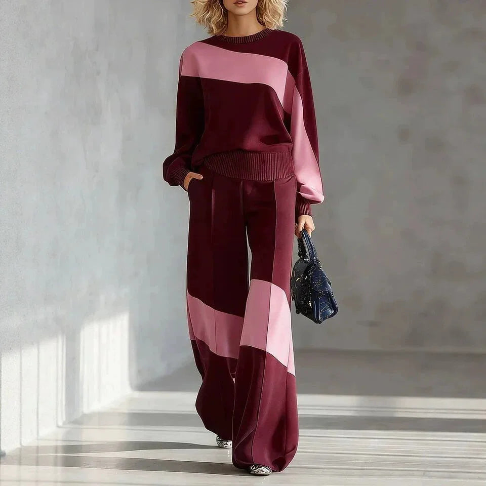 Woman wearing burgundy and pink color block sweater and wide leg pants set