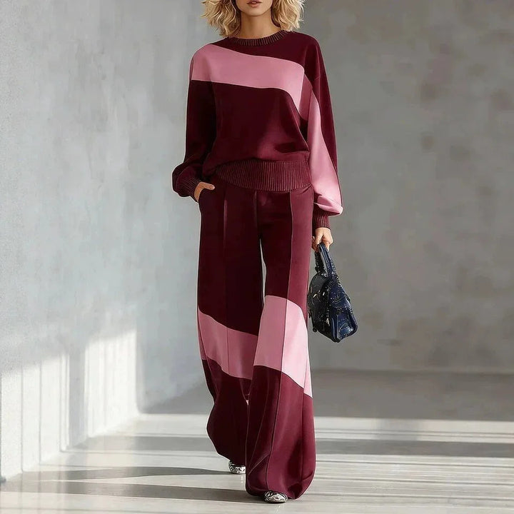 Woman wearing burgundy and pink color block sweater and wide leg pants set