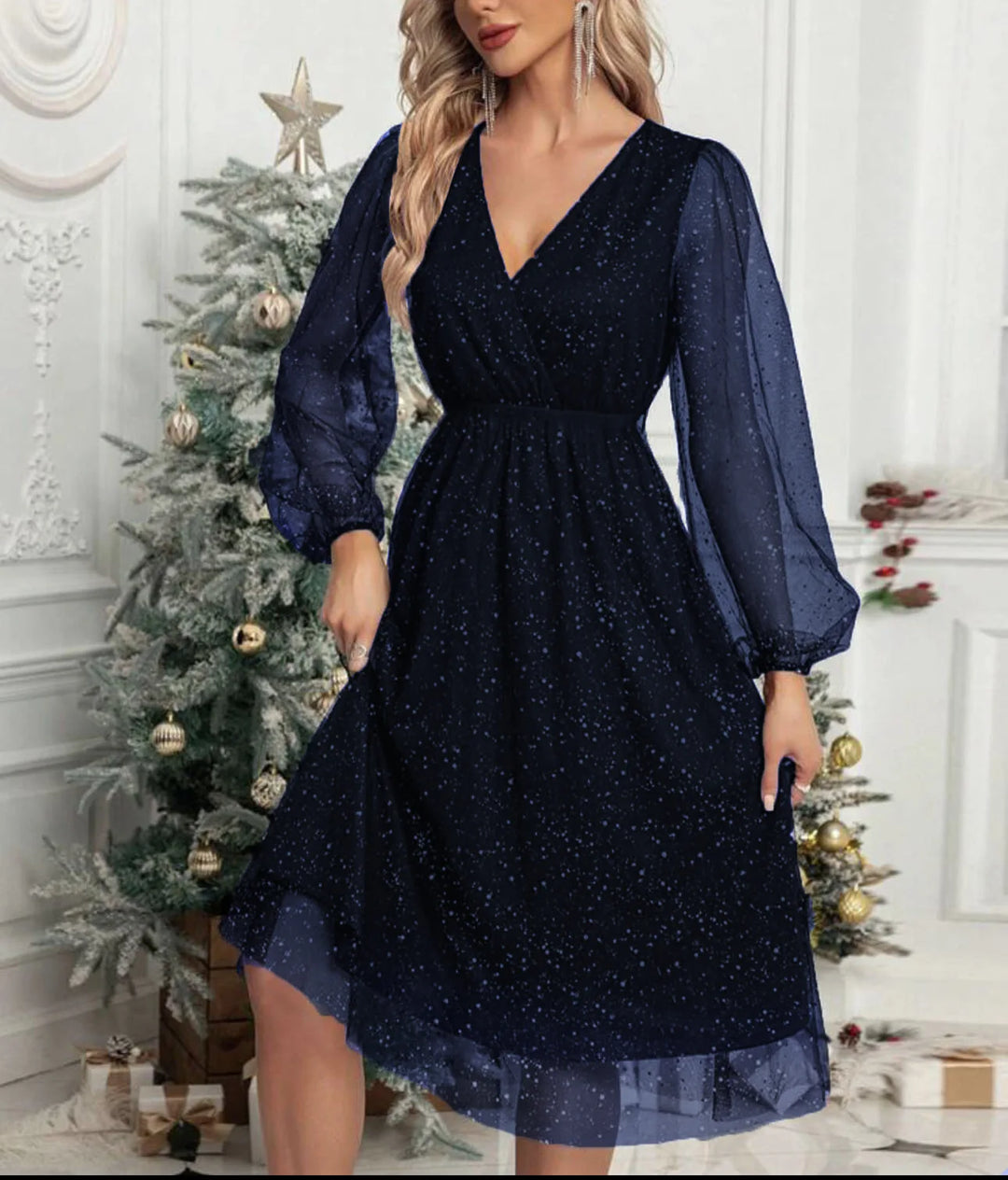 Woman wearing navy blue glitter mesh wrap dress with balloon sleeves