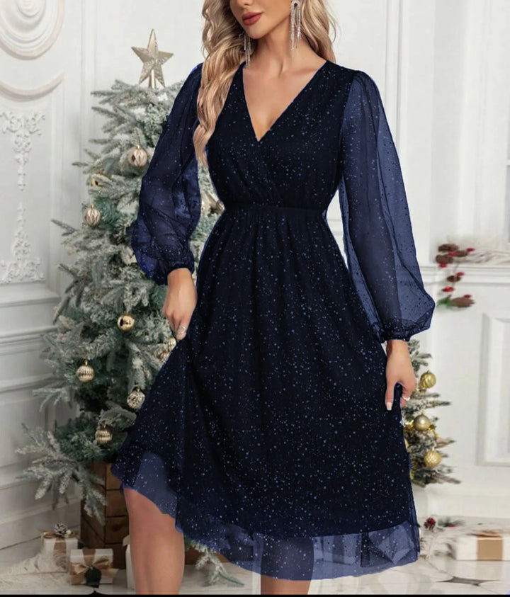 Woman wearing navy blue glitter mesh wrap dress with balloon sleeves